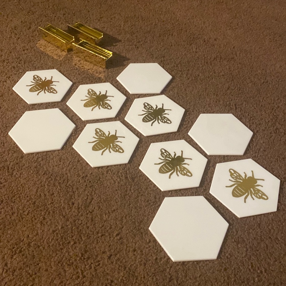 Coasters with bee design on one side only other side is blank.
